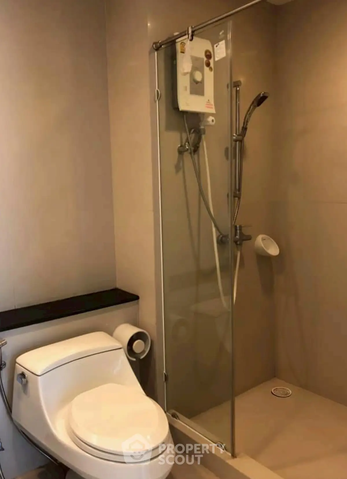 Modern bathroom with sleek shower and toilet in contemporary apartment.