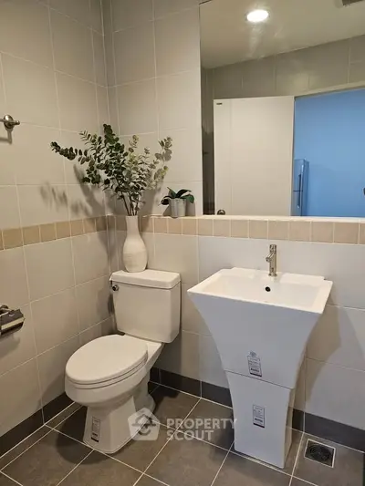 Modern bathroom with sleek pedestal sink and elegant decor