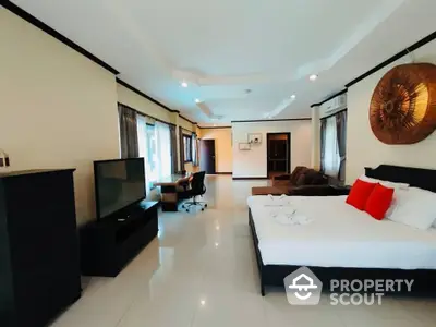 Spacious bedroom with gleaming tiled floors, modern furnishings, and ample natural light, perfect for a luxurious living experience.