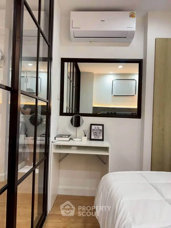 Modern bedroom with sleek design, featuring air conditioning and stylish decor.