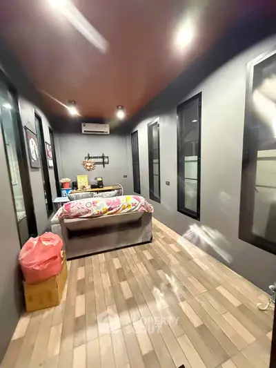 Modern bedroom with sleek design and ambient lighting, featuring large windows and stylish decor.
