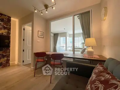 Modern living room with stylish decor and large windows offering natural light.