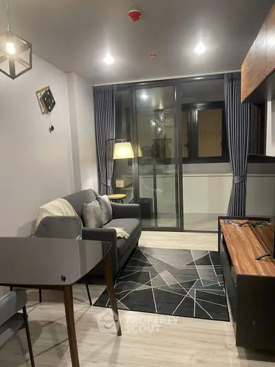 Modern living room with stylish decor and large windows in a contemporary apartment.