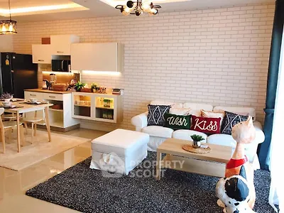 Stylish open-layout living room with modern kitchen and cozy seating area