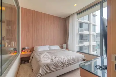 Modern bedroom with large window and city view, featuring cozy bed and stylish decor.