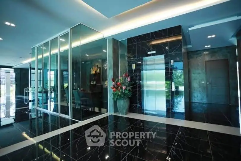 Luxurious modern building entrance with sleek black marble floors and glass walls