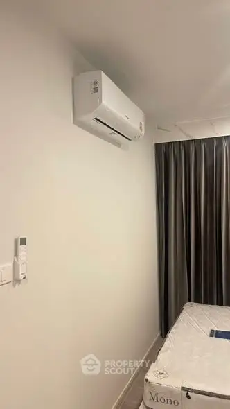 Modern bedroom with air conditioning and elegant curtains, perfect for comfortable living.