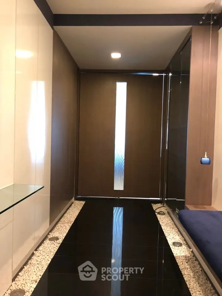 Modern entrance with sleek design and glass accents in a contemporary building.