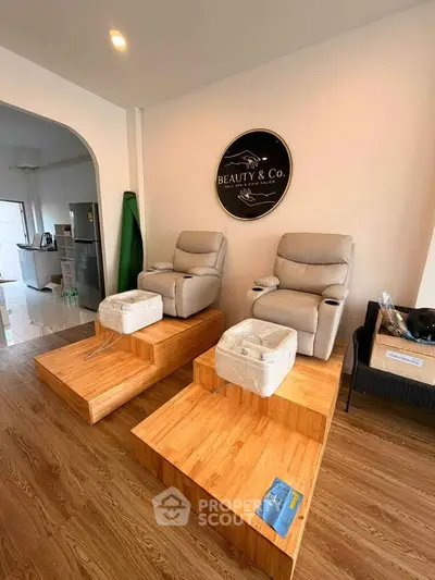 Chic salon interior with plush pedicure chairs and stylish wooden flooring, perfect for a relaxing beauty experience.