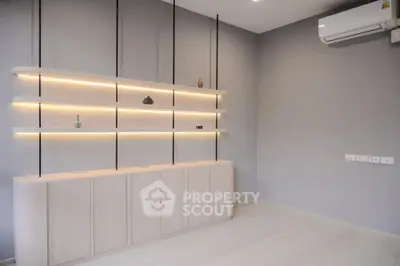 Modern minimalist living room with sleek shelving and air conditioning