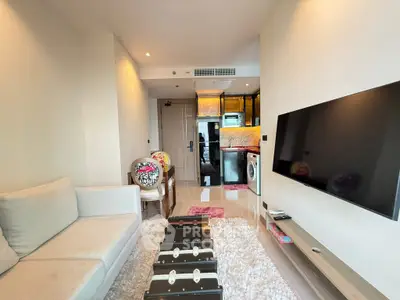 Modern living room with cozy sofa, stylish decor, and open kitchen layout in a chic apartment.