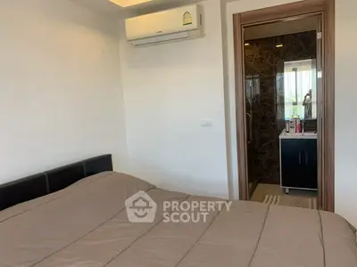 Cozy bedroom with ensuite bathroom and modern air conditioning unit