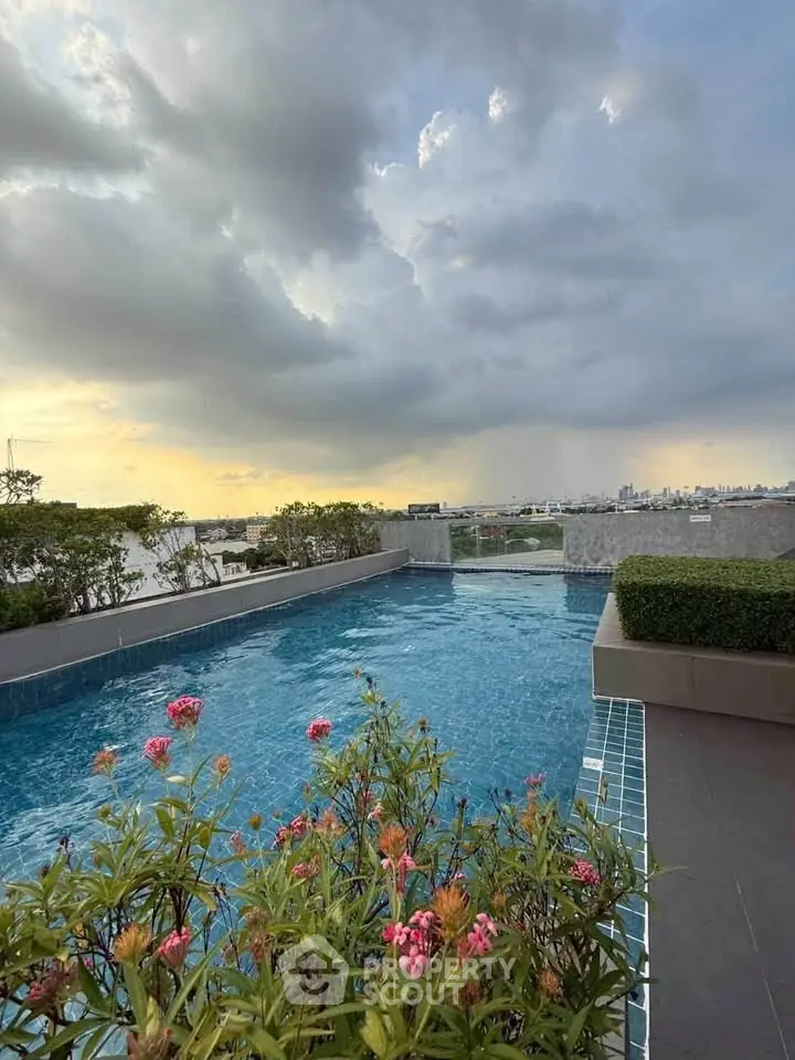 Stunning rooftop pool with panoramic city views and lush greenery