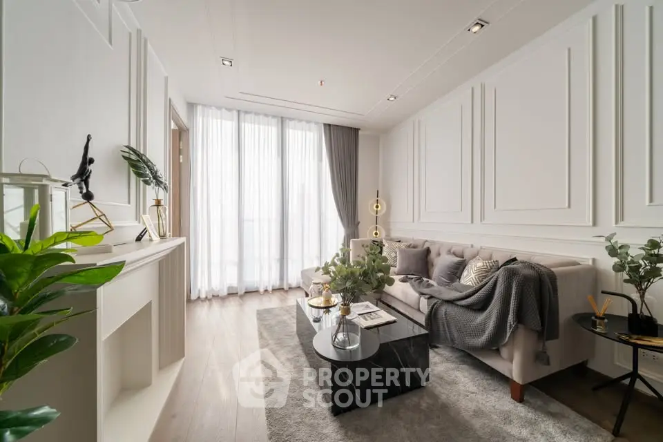 Elegant living room with modern decor, plush sofa, and natural light from large windows.