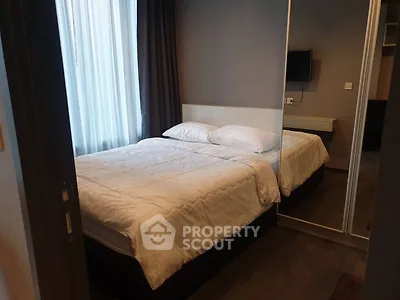 Cozy bedroom with modern decor and large mirror wardrobe