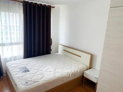 Cozy bedroom with natural light and modern furnishings, perfect for relaxation.