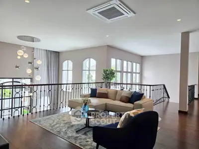 Luxurious open-plan living room with elegant decor and large windows for natural light.