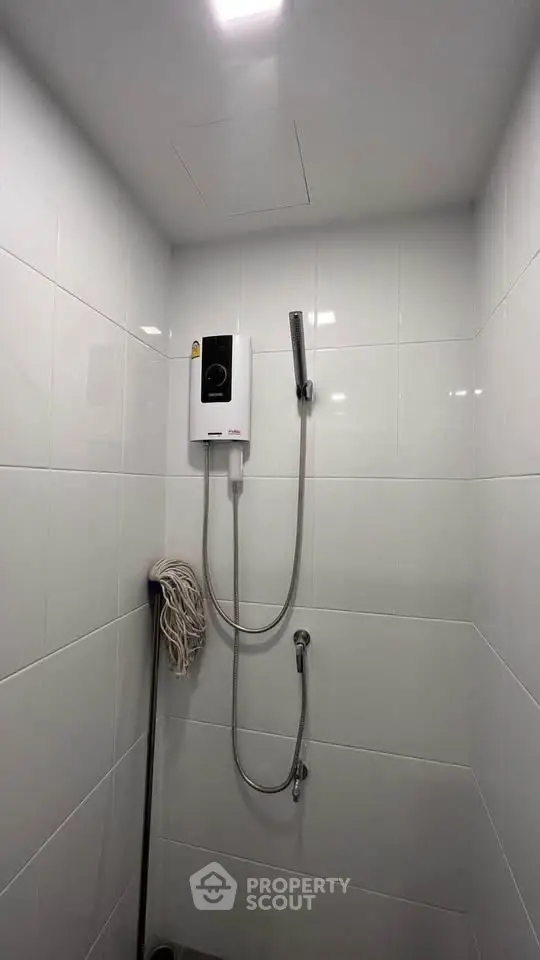Modern bathroom with sleek white tiles and shower unit