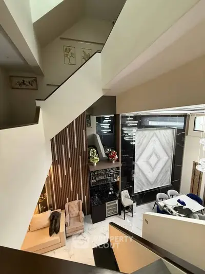 Luxurious modern living room with elegant staircase and stylish decor