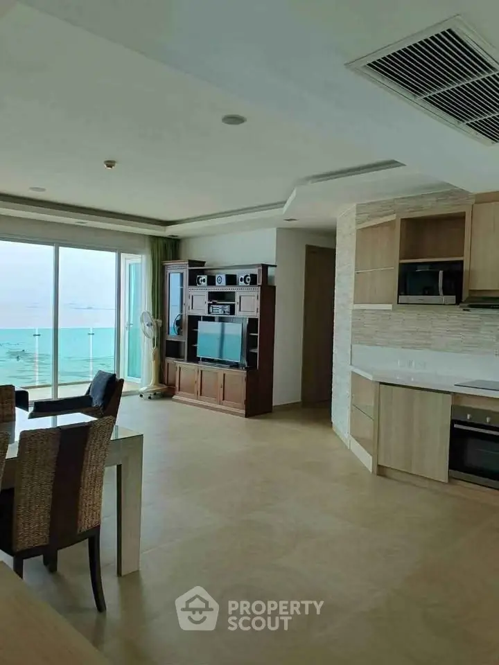 Stunning beachfront condo with open kitchen and ocean view, perfect for luxury living.
