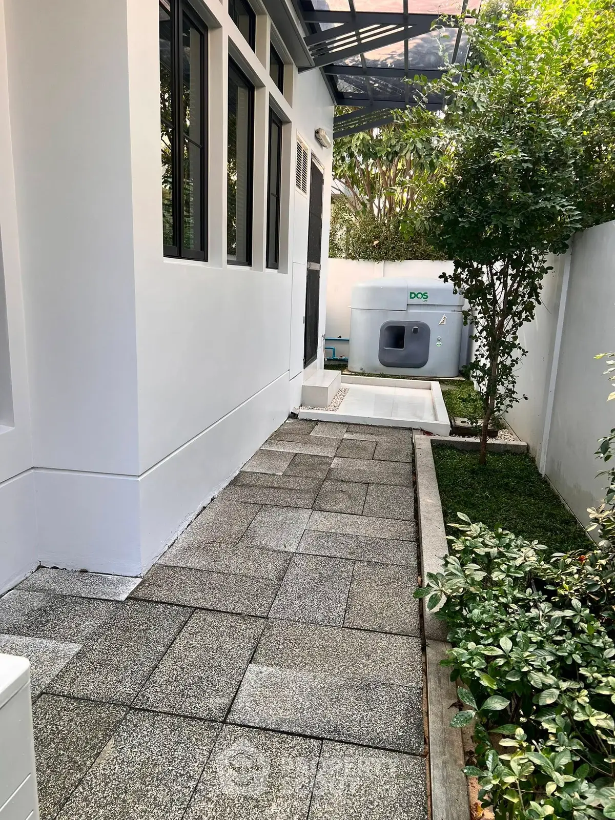 Charming garden pathway with modern exterior design and lush greenery.