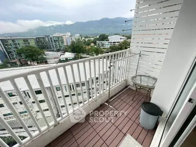 Charming balcony with mountain view in modern apartment complex