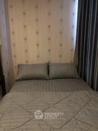 Cozy bedroom with elegant wallpaper and luxurious bedding
