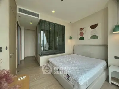 Modern bedroom with large window and stylish decor in a high-rise apartment.