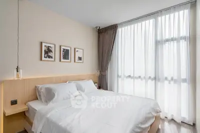 Bright and modern bedroom with large window and stylish decor