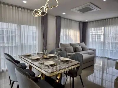 Elegant modern living room with stylish dining area and plush seating