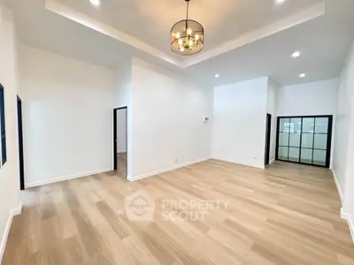 Spacious modern living room with elegant lighting and hardwood floors