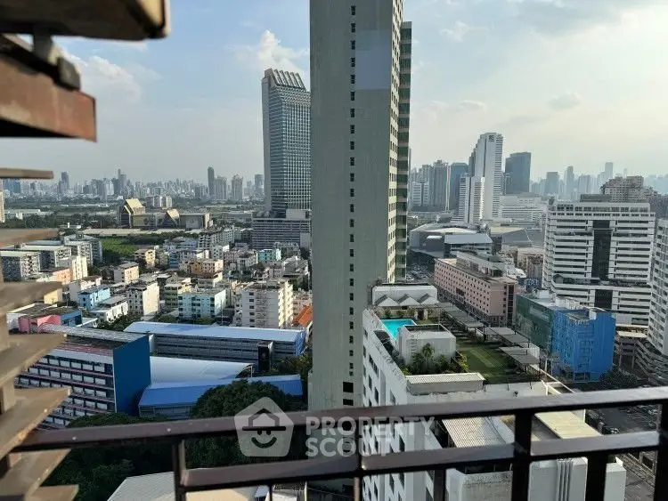 Stunning cityscape view from high-rise balcony overlooking urban skyline.