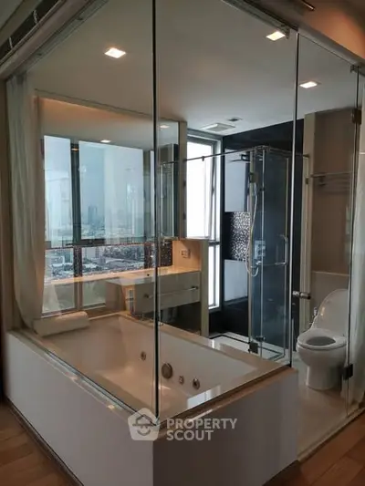 Luxurious modern bathroom with glass walls and city view, featuring a spacious bathtub and sleek shower area.