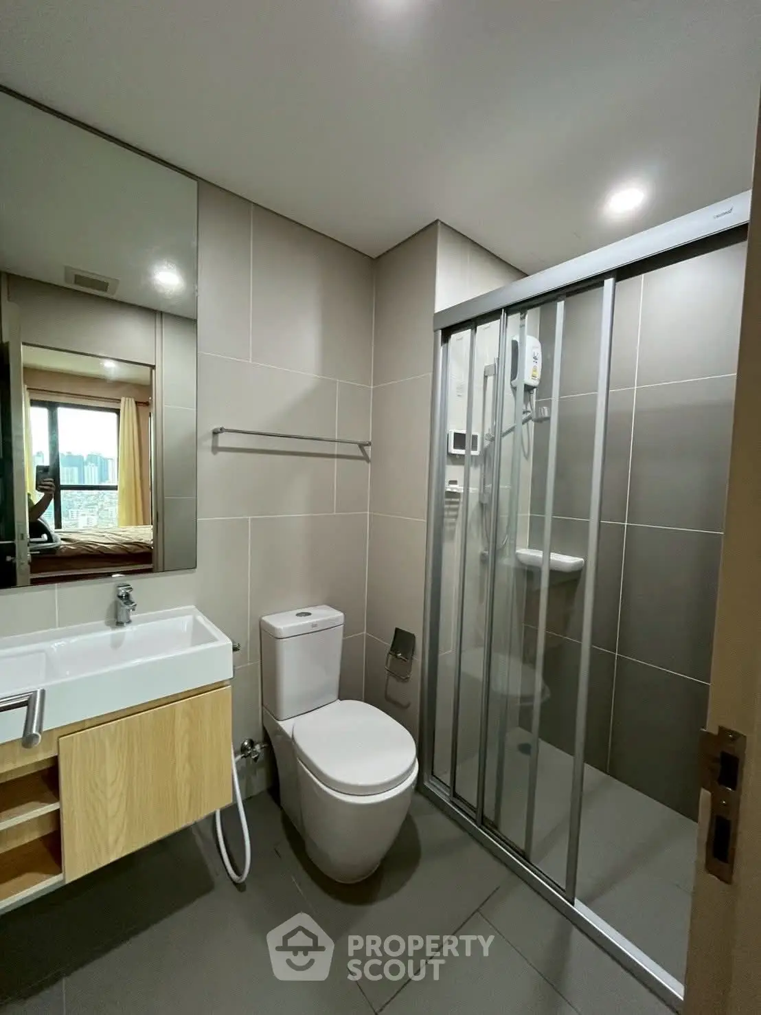 Modern bathroom with sleek shower and stylish vanity in contemporary apartment.
