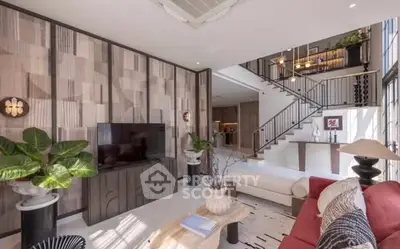 Luxurious modern living room with stylish decor and open staircase in a contemporary home.