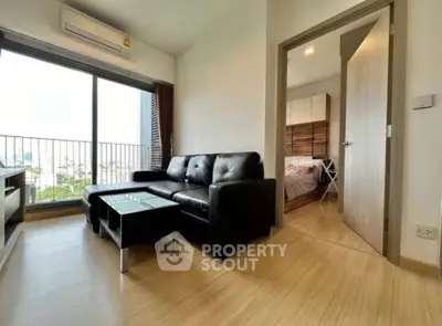 Modern living room with balcony view and adjacent bedroom in stylish apartment