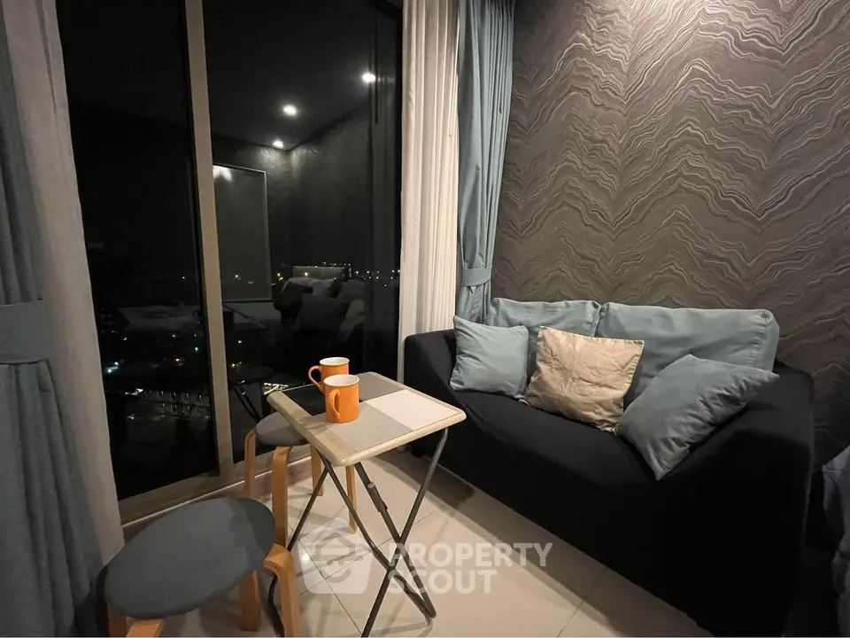 Cozy living room with modern decor and city view at night