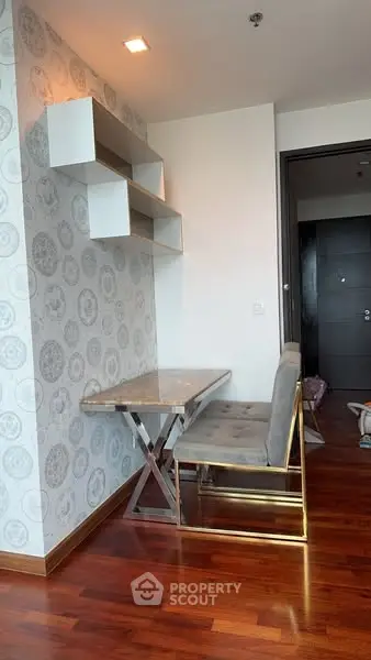 Modern study nook with stylish desk and shelving in elegant apartment.