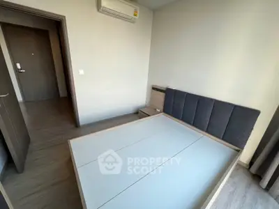 Modern bedroom with minimalist design and air conditioning unit