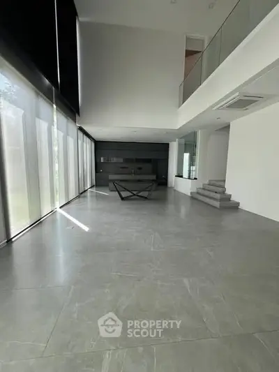 Spacious modern living room with high ceilings and large windows