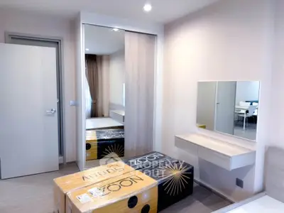 Modern bedroom with mirrored wardrobe and stylish furniture in a bright apartment.