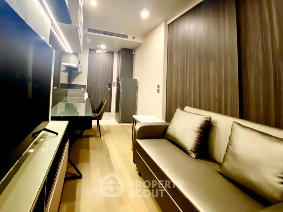 Modern living room with sleek design and cozy seating in a stylish apartment.