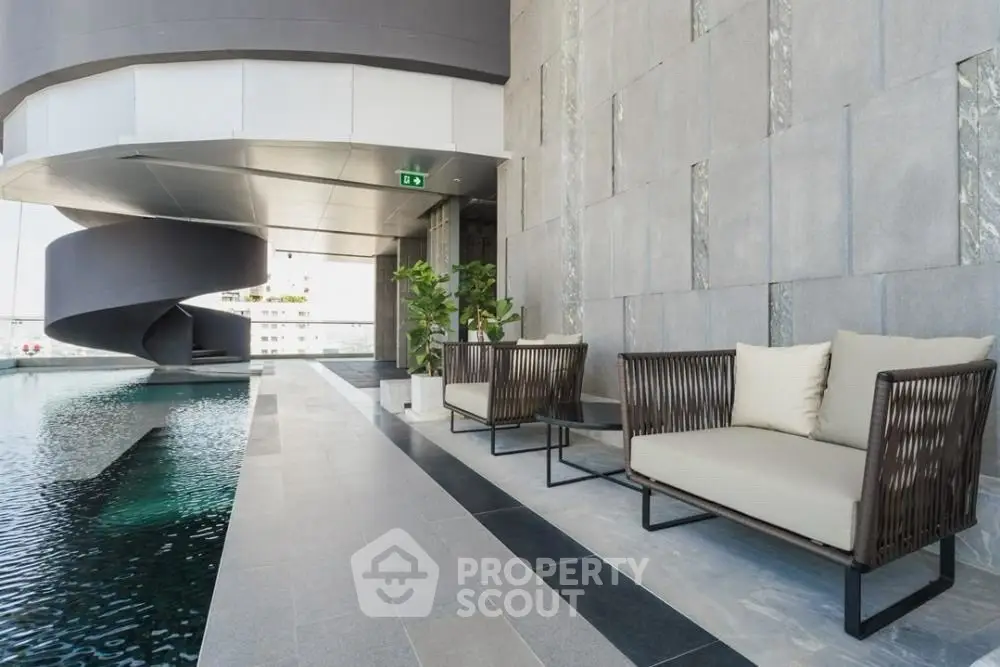 Luxurious rooftop pool area with modern seating and stunning city views.