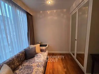 Cozy living room with elegant sofa and large window with city view