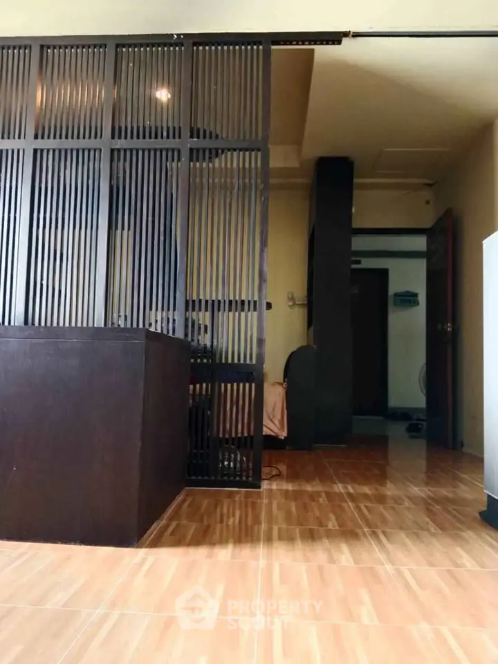 Modern interior with wooden partition and tiled flooring in a cozy living space.