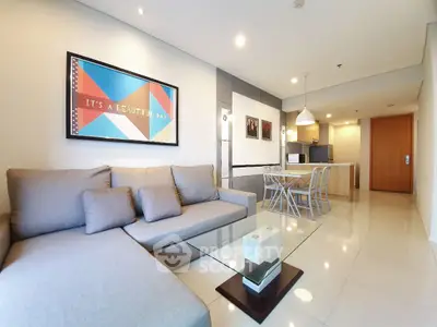 Spacious modern living room with stylish decor and open kitchen layout, perfect for entertaining.