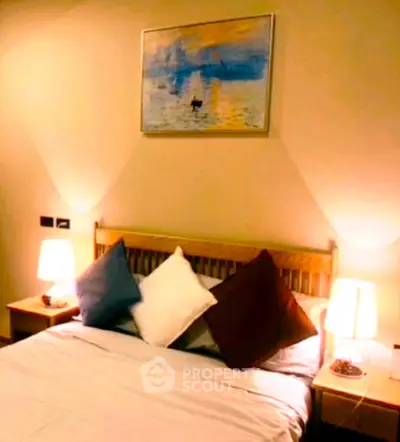 Cozy bedroom with stylish decor and ambient lighting, perfect for relaxation.