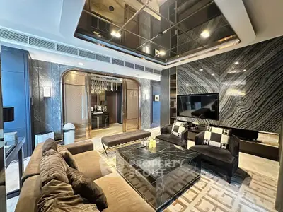 Luxurious modern living room with elegant marble accents and plush seating in a high-end apartment.