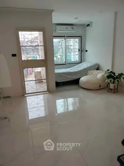 Spacious living room with large windows and modern decor