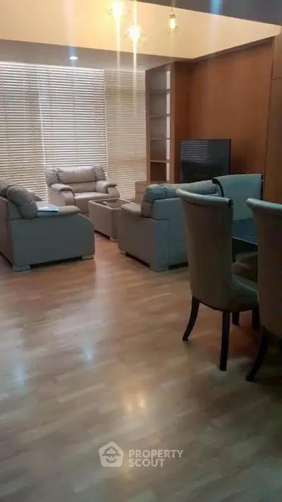 Spacious living room with elegant furniture and wooden flooring, perfect for modern living.